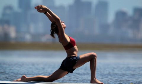 Practioners Enjoy Serenity Of Paddleboard Yoga